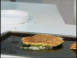Companies present robots which flip pancakes, serve drinks News Clip