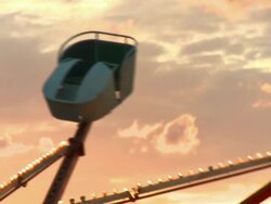 CU spinning fairground ride with orange sunset / Browning, Montana Stock Footage