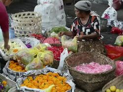 MS Vendor selling blossom for ceremony in market / Ubud, Bali, Indonesia Stock Footage