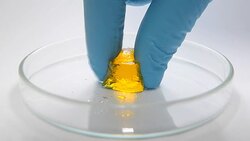 weight bearing experiment of yellow gel with human hand Stock Footage