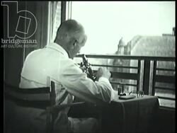 Scientists working with microscopes and close-ups of organisms. France, 1940s Stock Footage