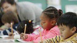 Teacher works with her elementary school students in class Stock Footage