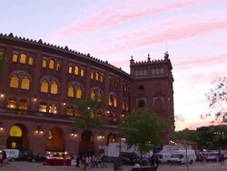 WS PAN Shot of people roaming at Plaza de Toros outside at dusk / Marid, Spain Stock Footage