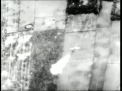 A fighter jet drops bombs over Vietnam in the 1960s. News Clip