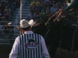 Cowboy rides a bucking bronco at a rodeo - shot in slow motion. Stock Footage