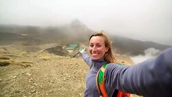 Young woman takes selfie portrait at the Emerald lakes, Tongariro Stock Footage