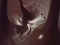 CU SLO MO Blocks of chocolate falling into chocolate liquid Stock Footage