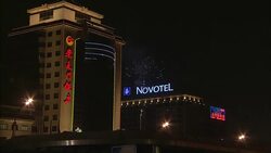 Fireworks explode above hotels during a Chinese New Year celebration. Stock Footage