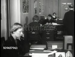 1936: U.S. THEATRE PRODUCER: FLANAGAN: WS McLean House, traffic FG, Washington D.C. INT WS Female secretaries at desks. MS Theatre producer Hallie Flanagan (1889-1969) talking to two men at desk. MS Flanagan talking. New Deal, Great Depression Instructional Video