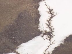 MS AERIAL Shot of Filigree melting pattern of snow / Iceland Stock Footage