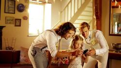 Groom taking selfie with groomsman and flower girl using camera phone Stock Footage