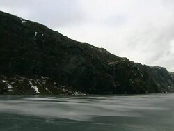 Steep dark mountains either side of fjord, Bjerkreim, Gjesdal County, Norway Stock Footage