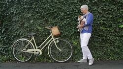 Woman with dog on bicycle Stock Footage
