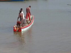 Fishermen paddle out to sea / Muttom, India Stock Footage