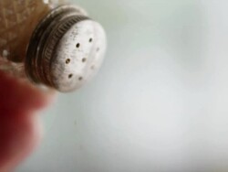 Cinnamon shaken out of dispenser by hand Stock Footage
