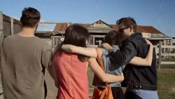 Group of friends approach Texas ghost town and walk through main entrance Stock Footage