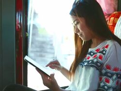 HD:Young business woman playing tablet on the bus. Stock Footage