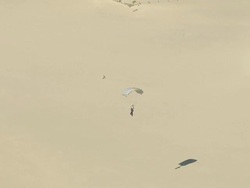 WS AERIAL TS View of parachutist at Guinchos beach in Cascais / Lisbon, Portugal Stock Footage