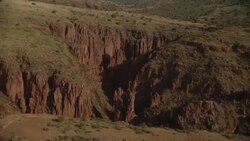 Jagged rock formations cast shadows into a gorge. Stock Footage