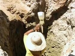 MS Shot of Man digging to reach water / Pilao Arcado, Bahia, Brazil Stock Footage