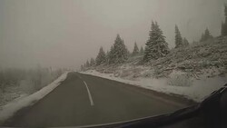 Driving on winding winter highway Stock Footage