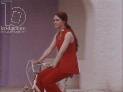 Fashion Collection Spring-Summer 1971 - Women modelling clothes while riding bicycles Stock Footage