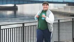 Heavy Hispanic man exercising, jogging on waterfront Stock Footage