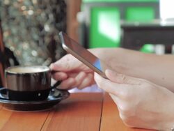 Using mobile phone and drinking coffee,Close up Stock Footage