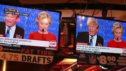 Hillary Clinton laughs at Donald Trump during their presidential debate, which is projected onto televisions at Nick's English Hut in Bloomington, Indiana. Stock Footage