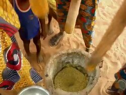 HA, CU, Three women using mortar and pestle for grinding millet grain, low section, Niamey, Niger Stock Footage