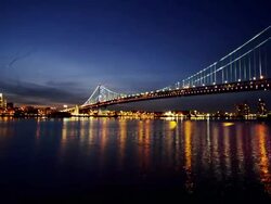 Night time, time lapse of Philadelphia cityscape, with Delaware River and Ben Franklin Bridge in foreground. Stock Footage