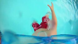 Young boy wearing goggles jumps into the water and goes underwater and the goggles spiral down(POV) Stock Footage