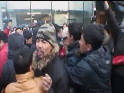 Apple Inc. postponed sales of its iPhone 4S in its mainland China stores Friday after angry customers and gangs of scalpers threw eggs at the company's flagship Beijing store. News Clip