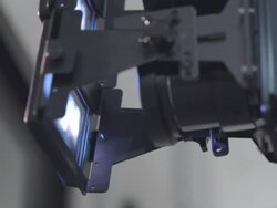 CU PAN 4K digital cinema projector lens and 3D split attachment projecting stereo images through projection booth glass partition  Stock Footage