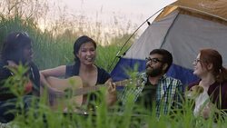 Playing Songs and Talking Around the Fire Stock Footage