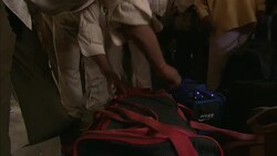 Police officers check bags on a train platform in India. Stock Footage