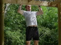 Male doing push up on bar in park Stock Footage