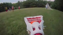 A lacrosse stick scoops a ball off the ground and  then cradles and tosses it. Stock Footage