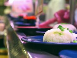 HD:Dishes of Sushi(Japanese traditional food)rolling on conveyer belt. Stock Footage