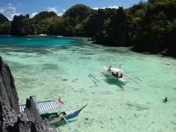 "WS tourists on boat floating in idyllic tropical inlet surrounded by plants and sharp limestone cliffs / Small Lagoon, Miniloc Island, Bacuit Archipelago, El Nido, Palawan, Philippines" Stock Footage