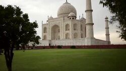 Pan shot of Taj Mahal through trees on rainy day. Stock Footage