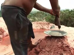 MS TS Shot of man washing cloth in iron pan at Gold mining / Jacobina, Bahia, Brazil Stock Footage