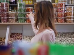 Woman buys jar of nuts in grocery Stock Footage