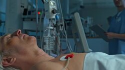 Nurse checking the monitor parameters of male patient in ICU Stock Footage