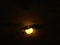 Full moon against the dark sky with clouds Stock Footage