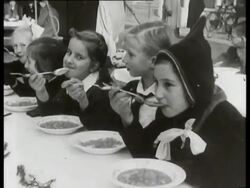 Personnel of the field-kitchen of the German Wehrmacht prepare soup for adults and children. Seyss-Inquart arrives and joins the group Stock Footage