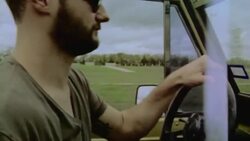 Driver laughs and bangs on steering wheel in classic Bronco Stock Footage