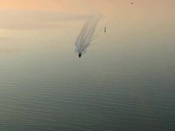 WS AERIAL View of Motor boat with sunset over Colington Island shore / North Carolina, United States Stock Footage