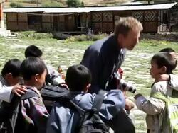 Professional Photographer talking to young children on there way to school, Bhutan, Asia Stock Footage