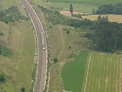 WS AERIAL TS Shot of express train running besides farm fields / Rhone Alpes, France Stock Footage